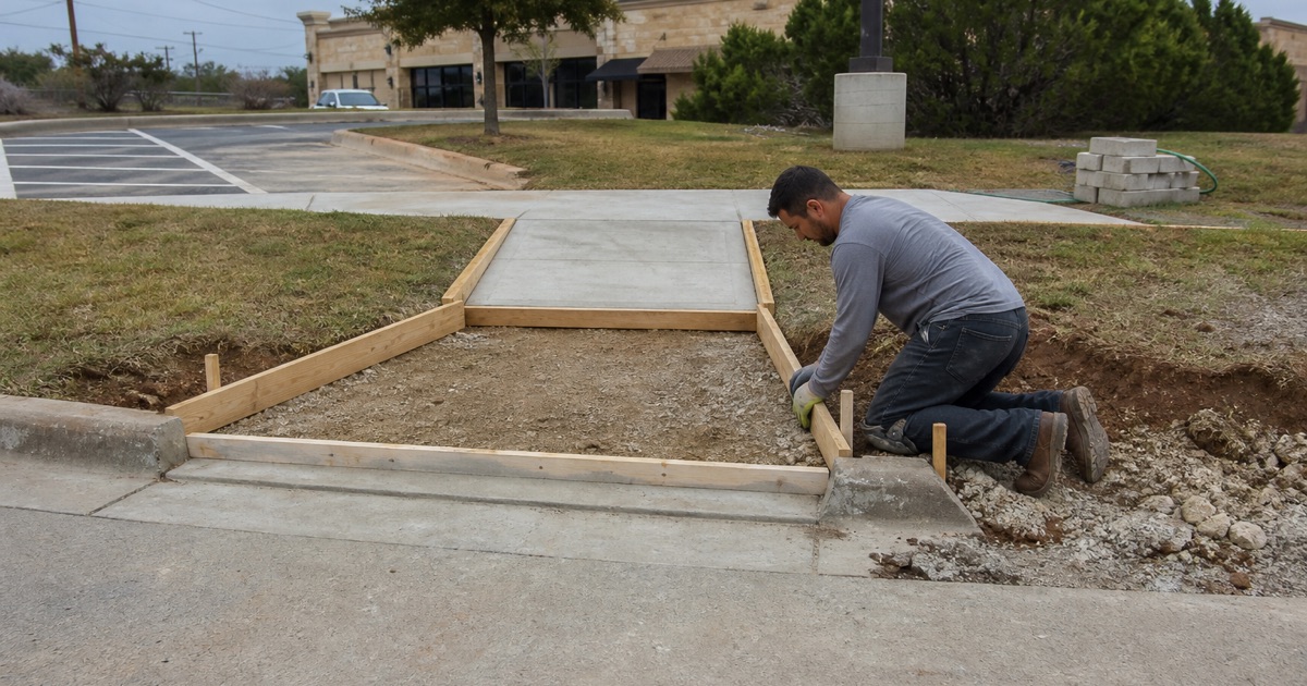 A curb ramp being formed at a curb return in Harker Heights, on a slope, with the buffer strip and walk running on behind it.